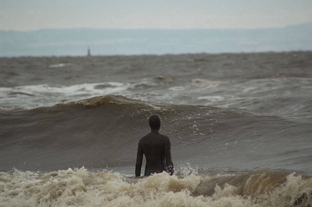 Antony Gormley Iron Man sculpture in River Mersey
